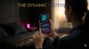 A cinematic shot of a person waking up in a dark, luxurious bedroom. They are looking at a sleek smartphone displaying glowing cyan and magenta biometric 'Readiness Score' data. A minimalist titanium smart ring is visible on their finger. Dark luxury aesthetic. Integrated title: THE DYNAMIC PROTOCOL.