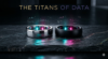 A cinematic, macro shot of two premium titanium smart rings resting on a dark, luxurious slate surface. One is sleek silver, the other is matte black. Glowing cyan and magenta holographic data streams surround them. Dark luxury aesthetic. Integrated title: THE TITANS OF DATA.